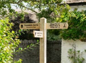 Ashton Keynes, United Kingdom - August 2018: Wooden signpost Thames Path, United Kingdom